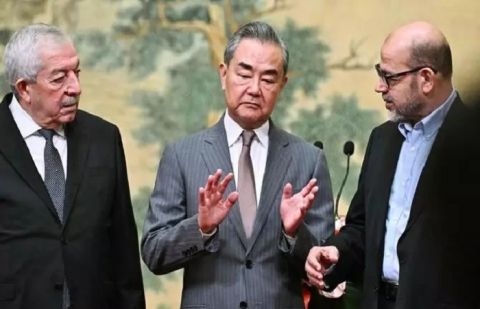 Mahmoud al-Aloul, vice chairman of the Central Committee of Fatah (L), China's Foreign Minister Wang Yi (C), and Mousa Abu Marzouk, senior Hamas member.