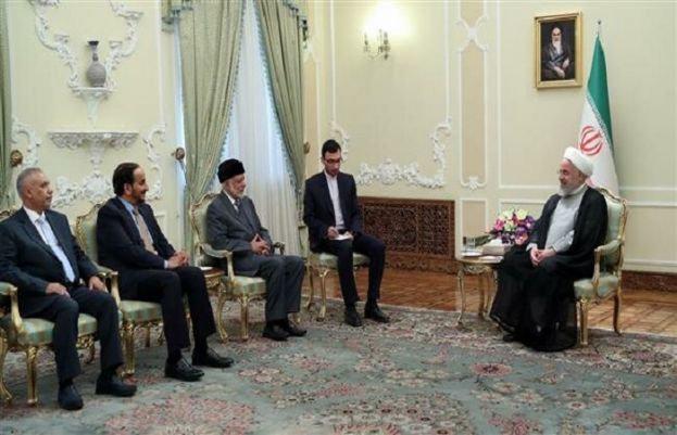 President Hassan Rouhani of Iran (R) meets with Omani Foreign Minister Yusuf bin Alawi in Tehran.