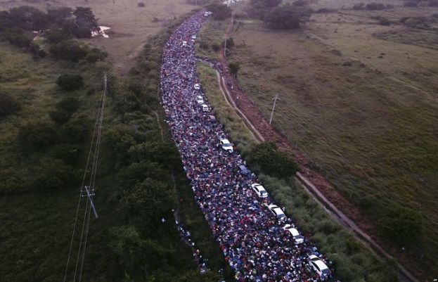 A migrant caravan cross a bridge between the Mexican states of Chiapas and Oaxaca after federal police briefly blocked them outside the town of Arriaga, Oct. 27, 2018.